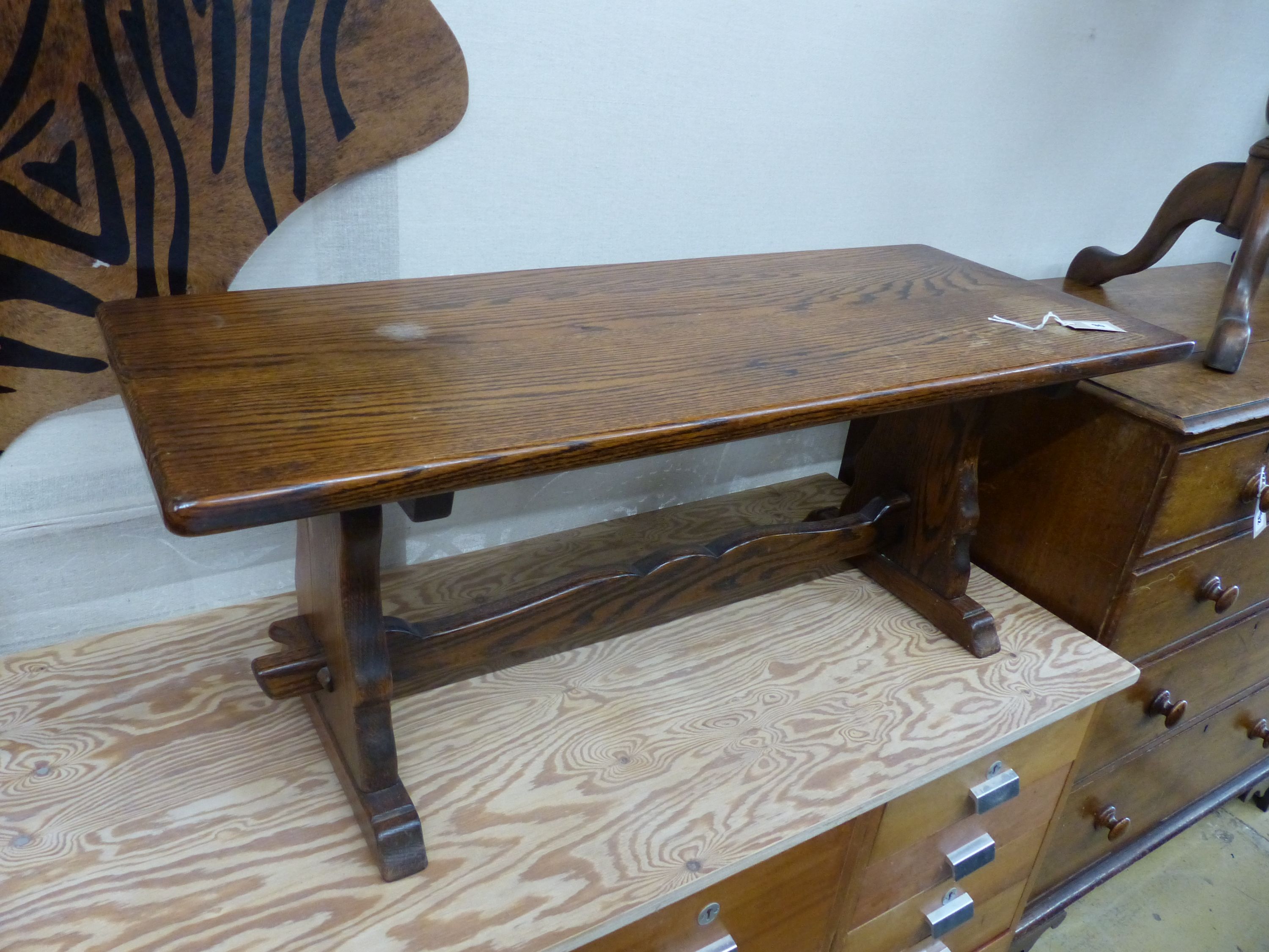 A circular mahogany occasional table on tripod base, diameter 60cm, height 70cm together with a rectangular oak low occasional table, width 106cm, height 42cm